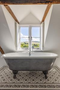 La salle de bains est pourvue d'une baignoire et d'une fenêtre. dans l'établissement Burnt House Alfriston, Sussex (London-95 mins), à Alfriston