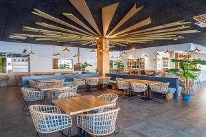 a restaurant with tables and chairs and a bar at Playa de la Luz in Rota