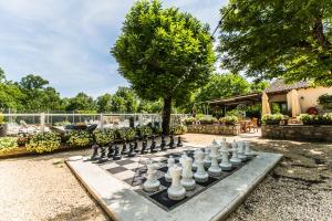 a chess board on a table in a yard at Camping La Digue in Chauzon