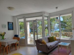 a living room with a couch and a table at Inas Place in Baška Voda