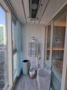 a bathroom with a toilet and a window at Ville apartment Sunneung Station&Coex free wifi in Seoul
