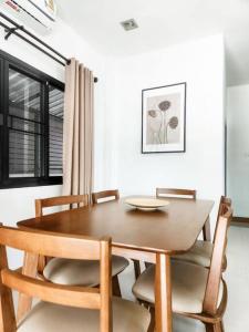 a wooden table and chairs in a dining room at Simple & Cozy Home in prime location. Chiang Mai in Chiang Mai