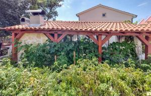 une pergola en bois dans un jardin avec des plantes dans l'établissement 1 Bedroom Amazing Apartment In Sibenik, à Šibenik 16 autres photos