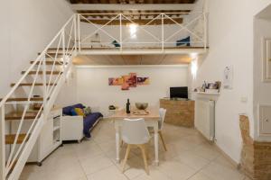 a living room with a loft bed and a table at Casa Vezzosa in Siena