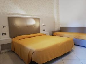 Postel nebo postele na pokoji v ubytování B&B Metropols Sottomarina