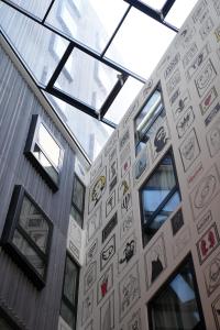 a wall of stickers on the side of a building at SO City Hotel Adults Only in St. Julianʼs