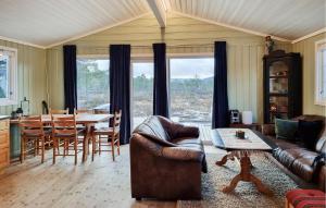 a living room with a couch and a table at Nice Home In Fossdal With House A Panoramic View in Fossdal