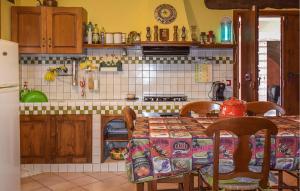 a kitchen with a table with chairs and a refrigerator at Nice Home In Bellante With Kitchen in Bellante