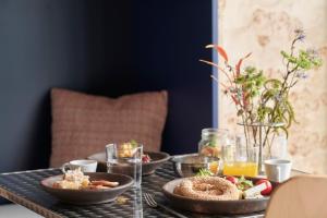 a table topped with bowls of food and drinks at The Newel Acropolis in Athens