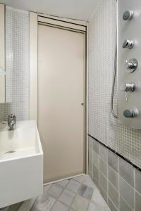 a bathroom with a shower and a white door at Charming Cozy Lavapies in Madrid