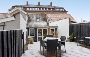 a patio with a table and chairs on a deck at 1 Bedroom Awesome Home In Middelfart in Middelfart