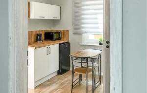 a small kitchen with a table and a microwave at Awesome Home In Lubniewice With Kitchen in Lubniewice