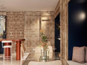 a dining room with a glass table and chairs at The Newel Acropolis in Athens