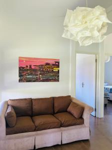 a couch in a living room with a painting on the wall at Twin House #2 in Ponta do Ouro