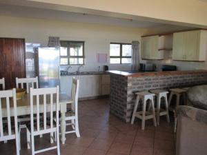 a kitchen with a table and chairs and a counter top at Sea View in Coffee Bay