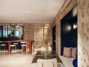 a living room with a table and chairs at The Newel Acropolis in Athens