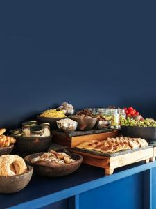 a table filled with lots of different types of food at The Newel Acropolis in Athens