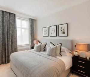 a bedroom with a large bed and a window at Quiet Luxury Escape for 6 in Covent Garden in London