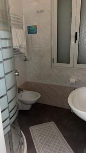 a bathroom with a toilet and a sink at B&B Metropols Sottomarina in Sottomarina