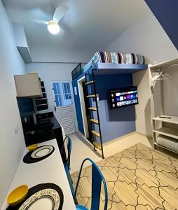 a room with a bunk bed and a desk at Studios Tiny House - Viva Essa Experiência in Sao Paulo