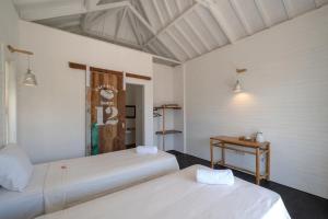Postel nebo postele na pokoji v ubytování Paus Putih Hotel
