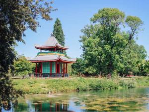 a pagoda in a park next to a body of water at Exquisite 3BR Duplex Period Conversion, Air-con & Amenities in London