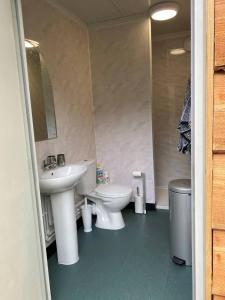 a bathroom with two sinks and a toilet and a mirror at Rhea Retreat - Bell Tent in Sittingbourne