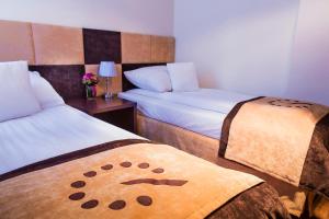 Postel nebo postele na pokoji v ubytování Boutique Hotel's III Piłsudskiego