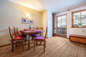 a dining room with a table and chairs at Lechnerhof Apt 3 in Braies