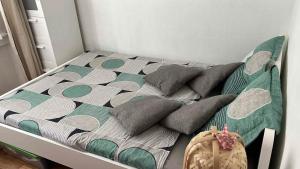 a bed with pillows on it in a bedroom at Lyon Chambre pour une personne chez Dalia in Lyon