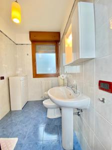 a bathroom with a white sink and a toilet at Nel Cuore della Natura - Parcheggio gratuito - Wi-Fi in Mezzolara