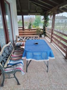 a table and two chairs sitting on a porch at Miladinović Bistrica in Bistrica