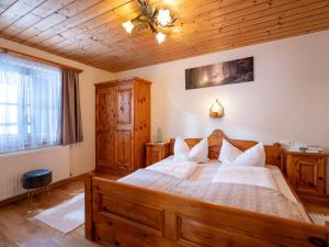 a bedroom with a large bed with wooden furniture at Haus Hofbichl in Itter