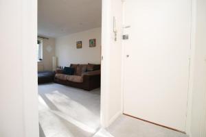 an open door to a living room with a couch at Cohost Partners- FREE Parking Close to town in Bath