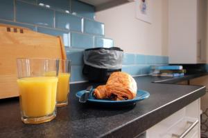 a plate of food and a glass of orange juice at Cohost Partners- FREE Parking Close to town in Bath