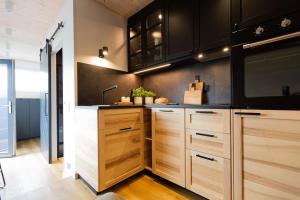 a kitchen with wooden cabinets and a sink at Good Spot Zieleniec Twin Eco 04 in Duszniki Zdrój
