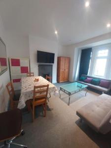 a living room with a table and a couch at London Zone 2, Easy Travel in London