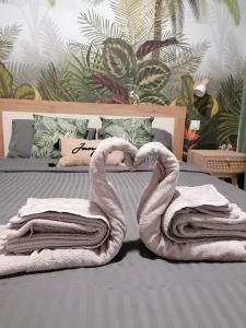 zwei Handtücher in Form von Schwänen auf einem Bett in der Unterkunft Escapades L'Isloises au cœur de L'Isle-sur-la-Sorgue. in LʼIsle-sur-la-Sorgue + 10 Fotos