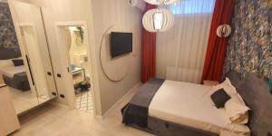 Postel nebo postele na pokoji v ubytování OITUZ Boutique Residence