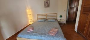 a bedroom with a bed with two slippers on it at Résidences Sopramare in Algajola