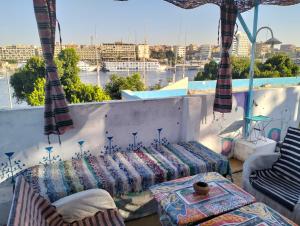 a balcony with a couch and a view of a city at Roma House in Aswan