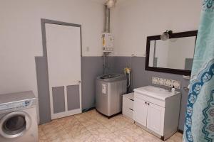 a bathroom with a washing machine and a washer at Ñuñoa Sunrise B&B in Santiago