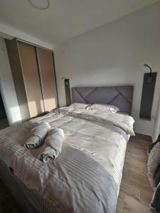 a bedroom with a large bed with towels on it at Hedonica 2 New Apartment in Vrdnik