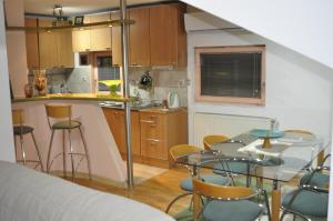 a kitchen with a table and chairs in a room at Luxury Apartment with parking space in Vodno