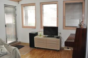 a living room with a television on a dresser at Luxury Apartment with parking space in Vodno