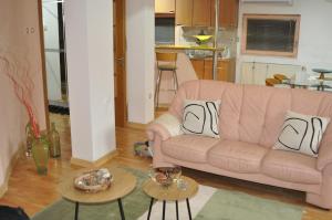 a living room with a pink couch and two tables at Luxury Apartment with parking space in Vodno +8 photos
