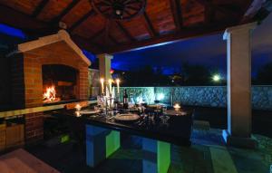 a bathroom with two sinks and a fireplace at night at Camino Apartment in Kaštela