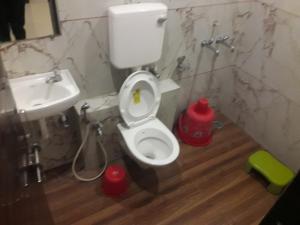 a bathroom with a toilet and a sink at HOTEL SAI MEERA PALACE in Shirdi