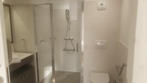 a white bathroom with a shower and a toilet at CAZAM VERNON-GIVERNY in Vernon