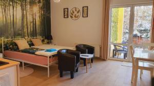 a living room with a couch and a table at Apartament 1 przy Termach Cieplickich in Jelenia Góra